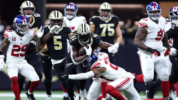 Dec 17, 2023; New Orleans, Louisiana, USA; New Orleans Saints running back Alvin Kamara (41) is tackled by New York Giants safety Jason Pinnock (27) during the second half at Caesars Superdome.